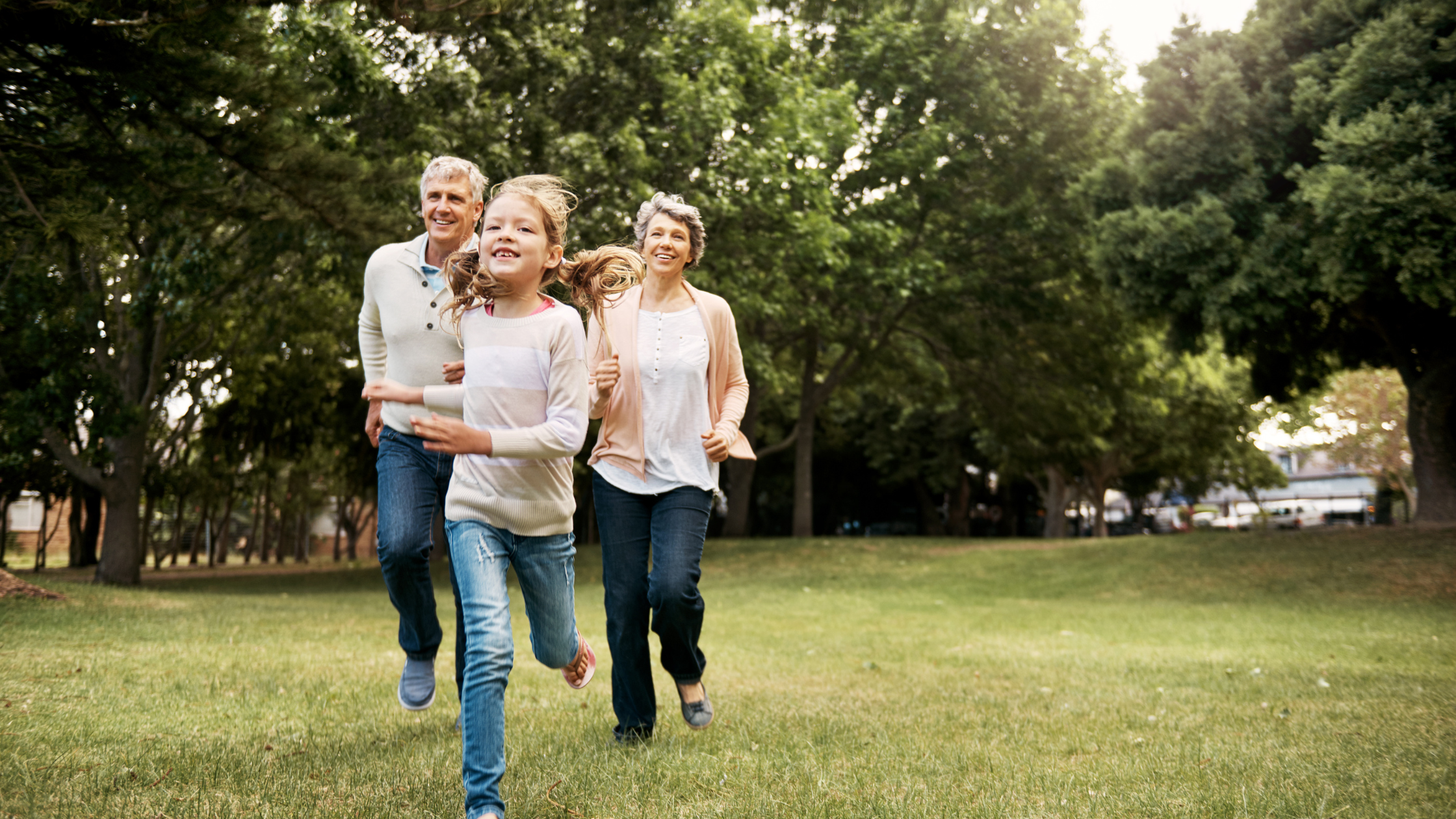 Energetic midlife couple chasing grandchild