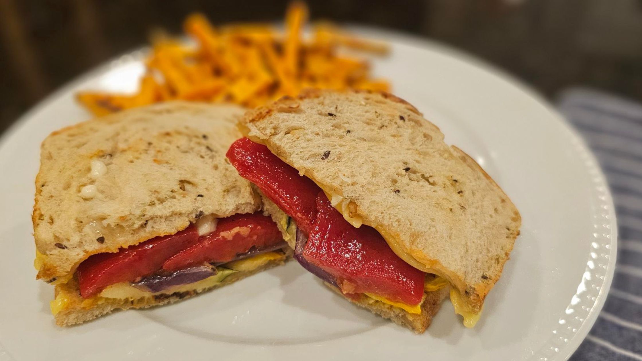 healthy plant-based vegan vegetable sandwich with sourdough, roasted peppers, squash and onion