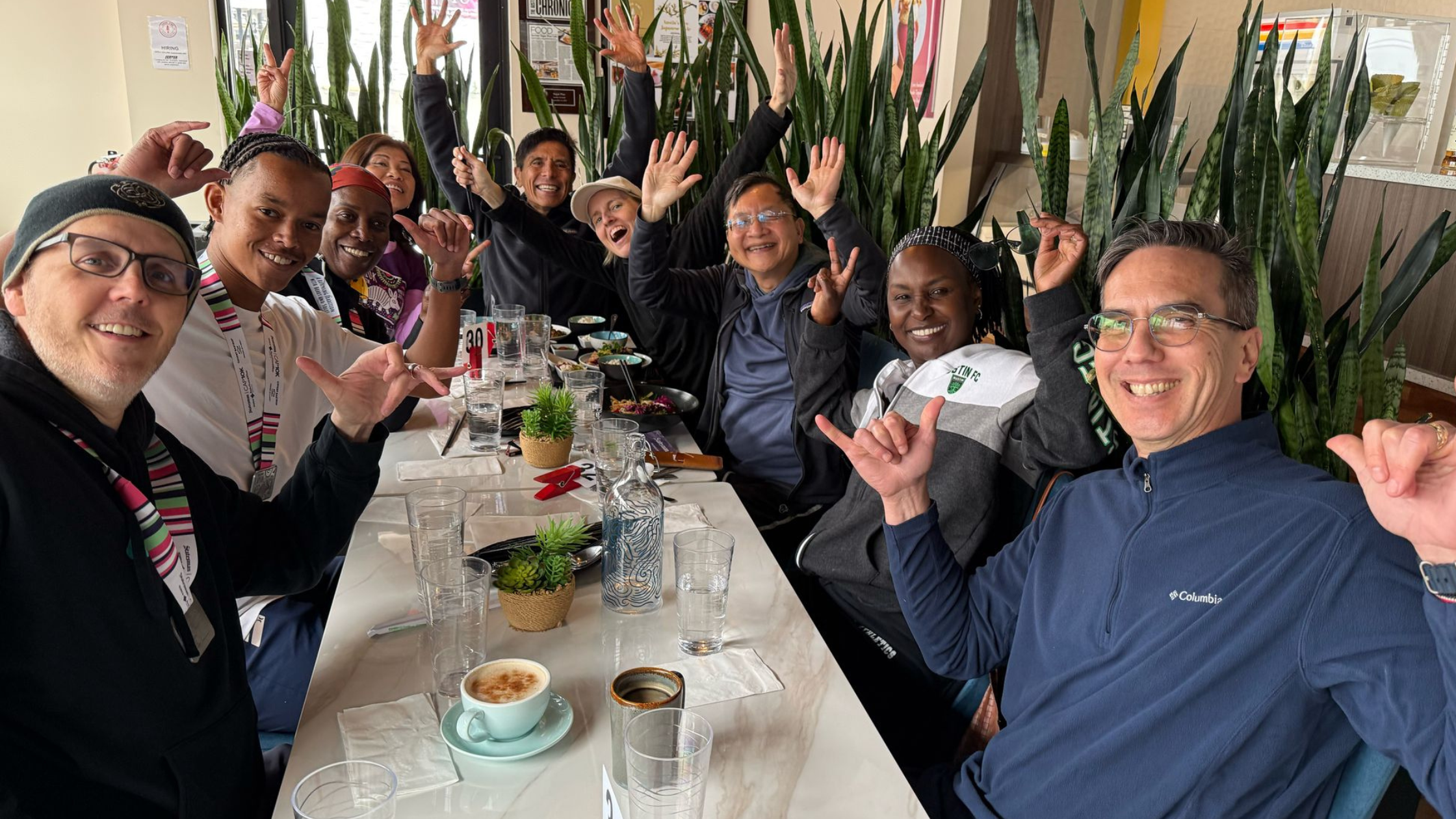 Group of people sharing a plant-based meal together around a dining table